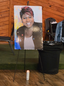 A picture of Monica Roberts with a white candle during family day.
