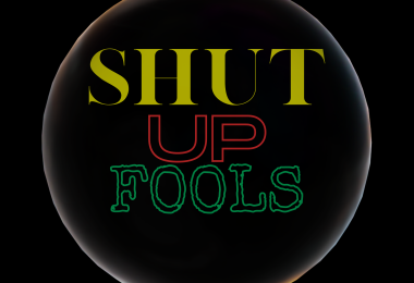 A Black square with Yellow red and green lettering spelling out Shut Up Fools surrounded by a bubble.