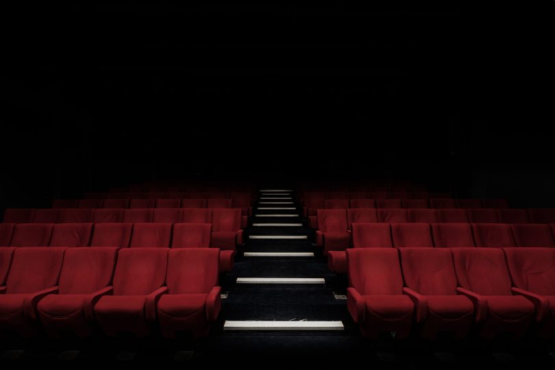A wide shot of empty red theater seats